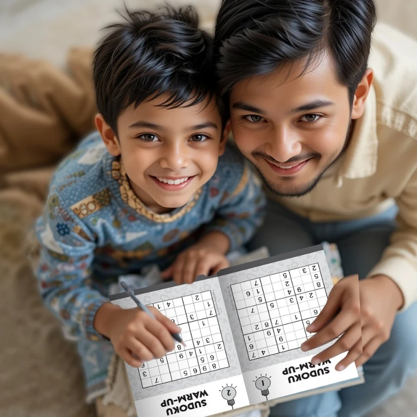 Father and young son smiling while solving Sudoku puzzles for beginners together. Both are holding pencils and looking up cheerfully, showing a warm moment of connection.