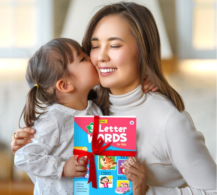 Mother and young child holding a colourful children's book titled ‘My First 3 Letter Words’ together.