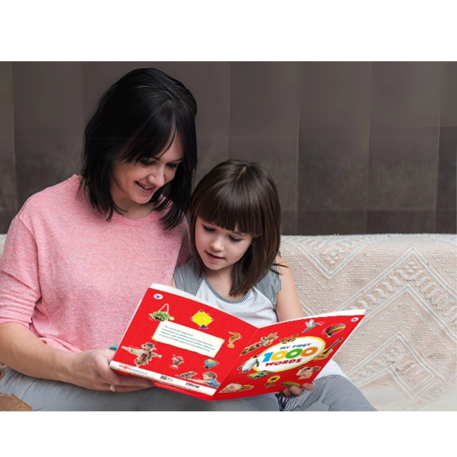 A mother reading the My First 1000 Words picture book with her child on a couch, promoting early literacy, parent-child bonding, and daily reading habits.