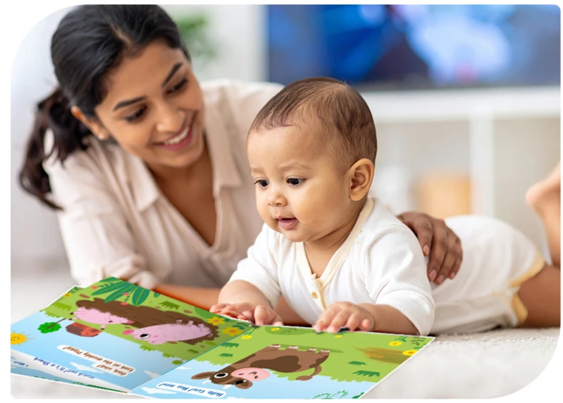 Mother bonding with baby during tummy time as they explore a colourful picture book together on the floor. Promotes early literacy, screen-free play, and parent-child connection.